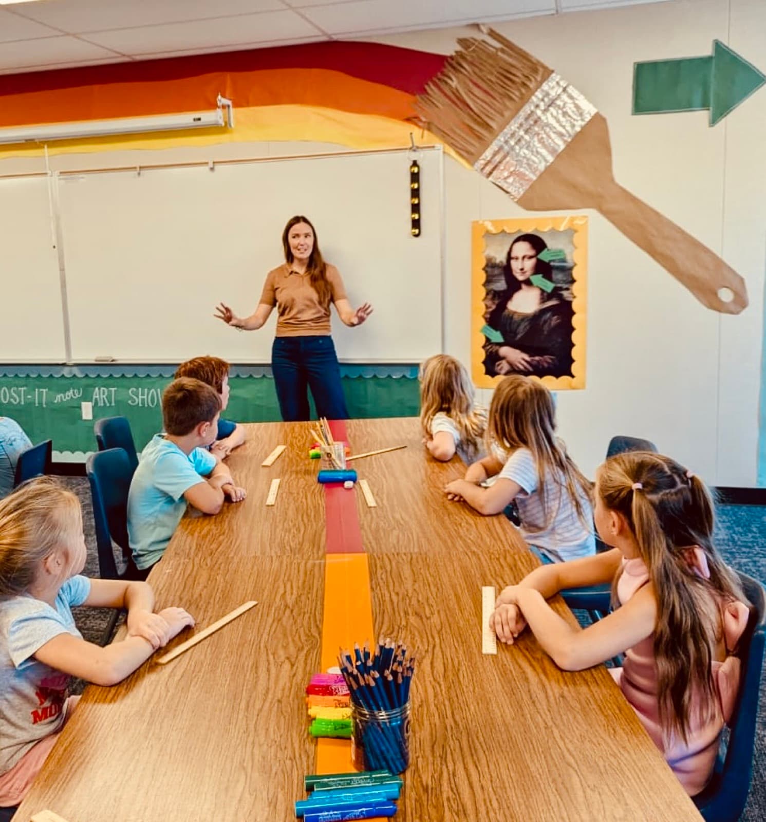 Eastbluff art teacher leading a lesson for students seated at the studio tables