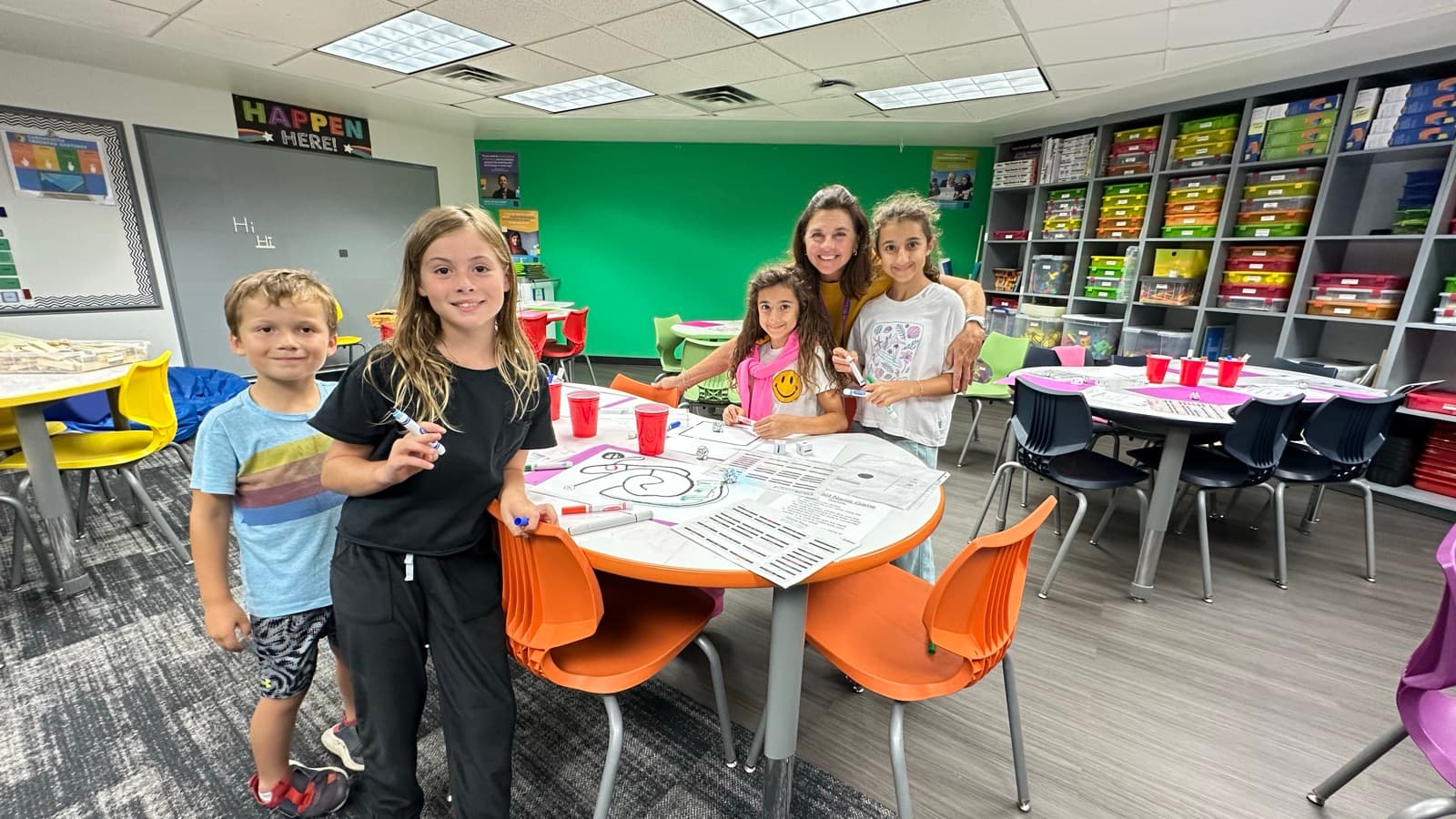 Mrs. Mannon and Eastbluff students gathered around a table in the Otter Lab